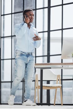 young man in a blue shirt talking on the phone