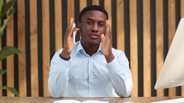 Portrait of a confident senior man businessman, accountant, manager sitting in the office at the table