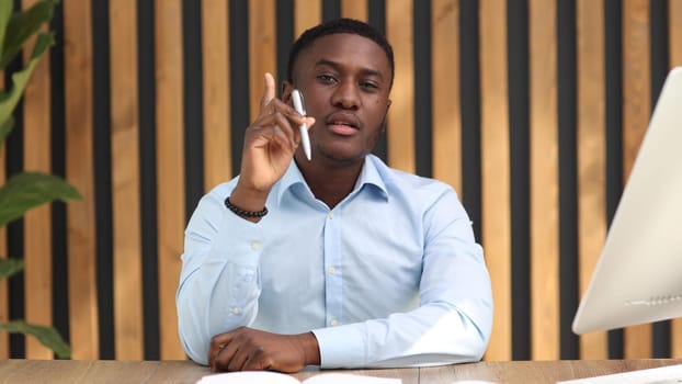 Portrait of a confident senior man businessman, accountant, manager sitting in the office at the table