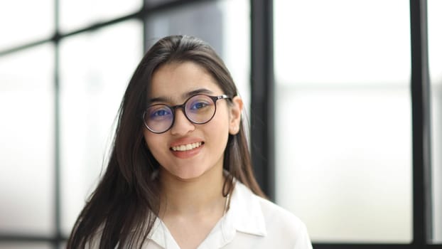 head shot portrait of a preppy, young, beautiful, confident and attractive woman