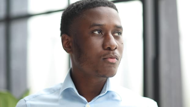 Portrait of an african american businessman in a blue shirt