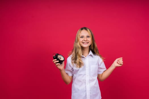 Teen girl 12, 13, 14 years old look alarm clock. Good morning, checking time. Positive emotions.