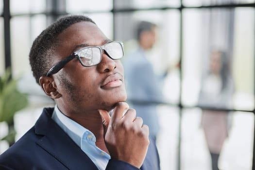 Pensive mixed race confident international company employee manager thinking of problem solution at office.