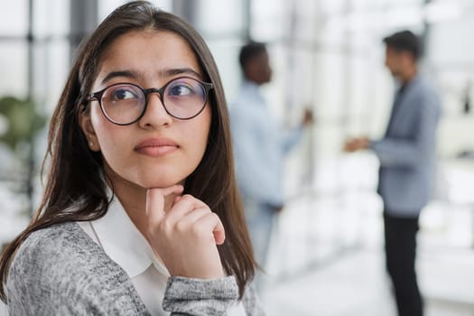 businesswoman inside office building looking at camera.