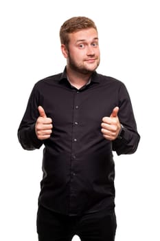 Image of young attractive man dressed in black shirt standing over white background looking at camera and showing thumbs up gesture. Body language.