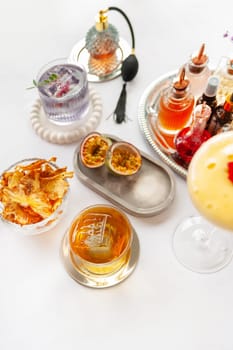 Five colorful summer cocktails in glasses on white table. Assortment of fresh summer drinks. Orange and red sangria cocktails, orange punch cocktail, margarita cocktail, tropical mule.