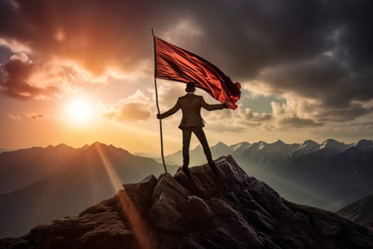 An inspiring image of a man standing atop a mountain peak, proudly holding a flag as a symbol of accomplishment.