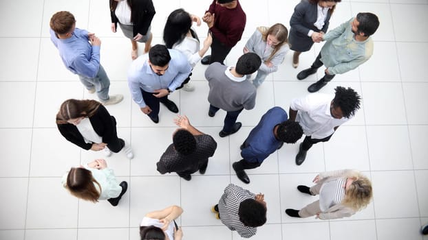 Group of company workers walking in office corridor