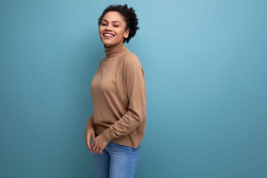 young pretty latin woman with curly hair isolated studio background with copy space.