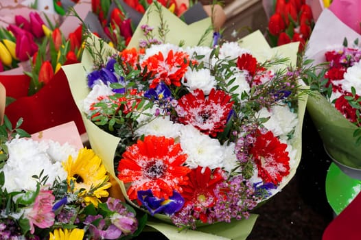 Mixed colorful flowers background. Vibrant colors of mixed flowers backdrop. gerbera, tulips and mix of summer flowers bouquet