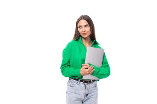 brown-eyed brunette young business lady in a green shirt with a portable computer laptop.