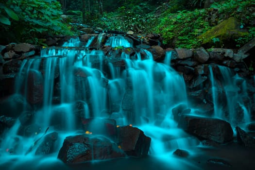 Landscape of multilevel waterfalls in Dlundung, Trawas, Mojokerto. Indonesia. Long Exposure Nature Photography.