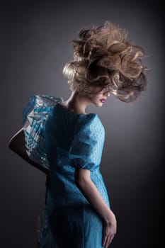 Rear view of pretty woman posing with creative hairstyle