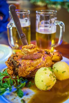 Deep fried pork knuckle  in Frankfurt, German with potato and beer 