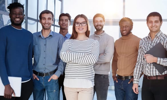 Business people in elegant casual clothes are standing in the office