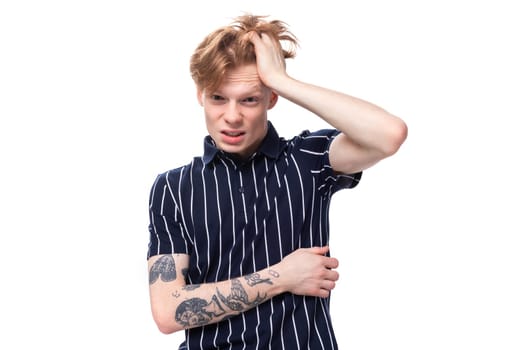 distressed 25 year old blond male with tattoos in a striped polo.