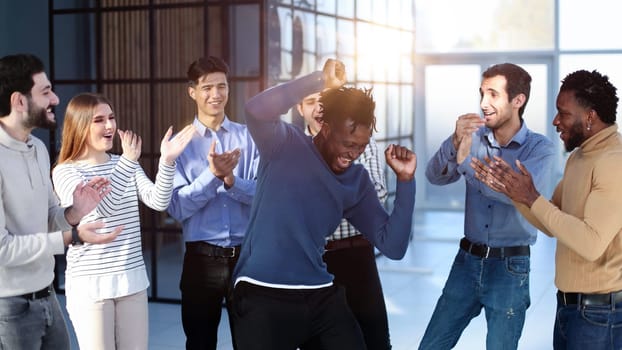 Business team of overjoyed professionals cheering, celebrating good sales result, financial goal achieving