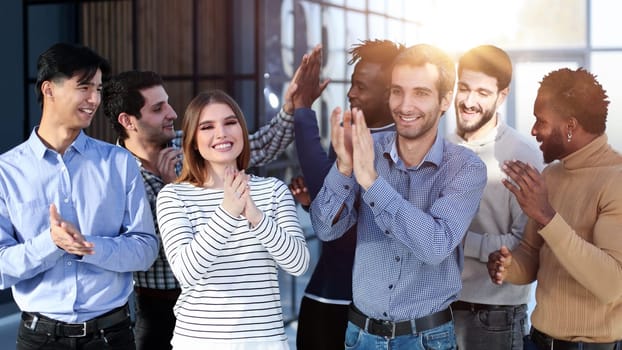 happy excited millennial employees shouting for joy, raising hands for emotional high fives.