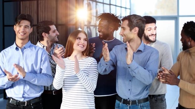 Happy satisfied multi-racial business people dressed in casual clothes cheering at camera after attending corporate seminar in office