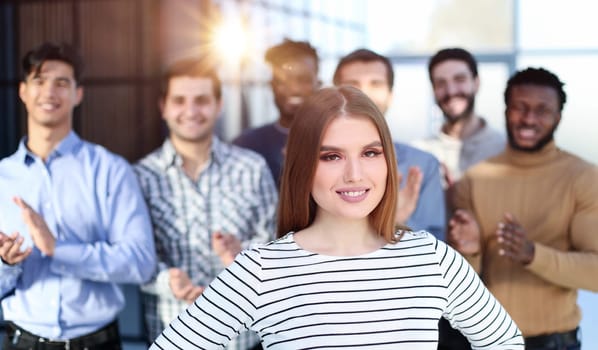 the team slaps the leader to the woman in the foreground. Success concept
