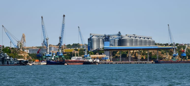 Sevastopol, Crimea - July 3, 2019. Grain terminal with capacity of 170 thousand tons and Dock bay with cranes for ship repair