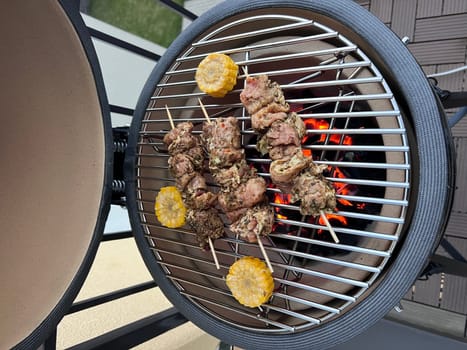 Egg grill cooking at home meat and corn kamado bono. High quality photo