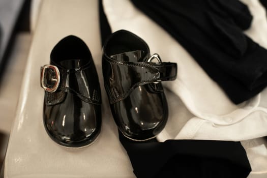 Patent leather shoes for a baby in a church for christening ready for baptism