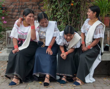 four indigenous sisters from a latin american tribe looking at camera. High quality photo