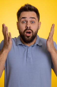 Oh my God, Wow. Excited amazed winner man surprise looking at camera with big eyes, shocked by sudden victory. Sincere confused shocked caucasian guy isolated on yellow studio background. Vertical
