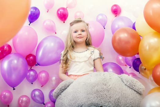Image of lovely young lady posing with colorful balloons