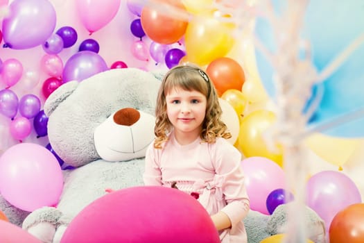 Image of smiling little girl posing in playroom