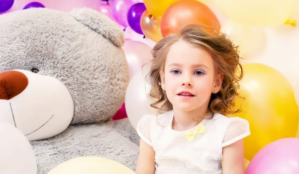 Portrait of beautiful little lady with big plush bear