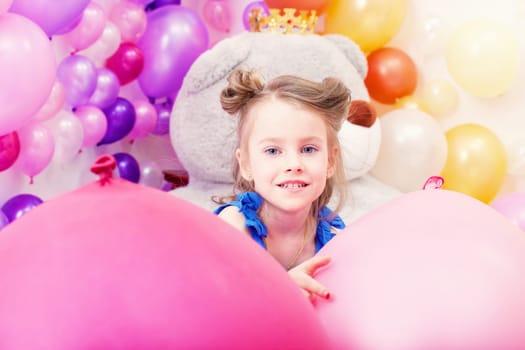 Portrait of beautiful little girl posing in playroom