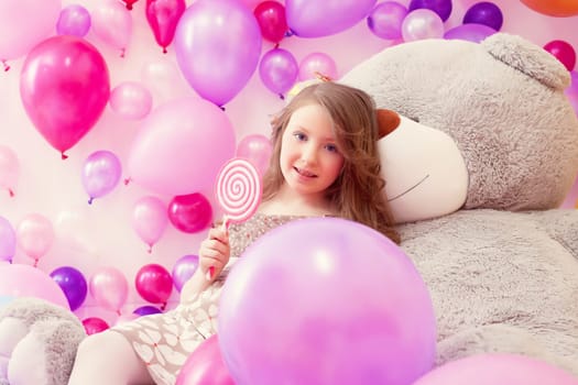 Pretty girl with lollipop posing looking at camera