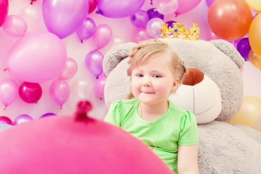 Image of amusing blonde girl posing in playroom
