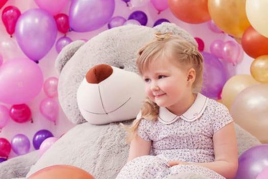 Studio shot of neat little girl posing in playroom, close-up
