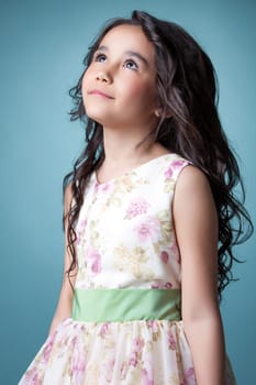 Studio shot of nice little girl posing looking up