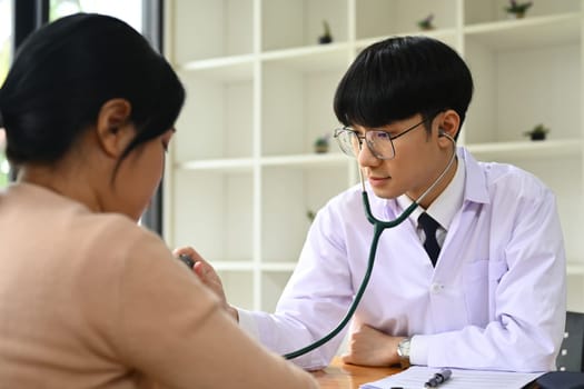 Doctor using stethoscope to checking heart and lungs of patient. ,Medical, consultation, diagnostic and health care concept.