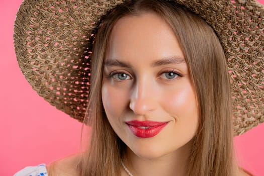 Pretty blonde woman, big lips on pink background. Smiling natural healthy girl lady with european appearance looking at camera. High quality photo