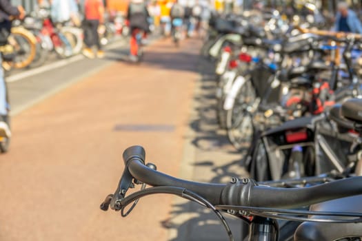 Netherlands. Sunny day in Amsterdam. Bicycle parking in defocus