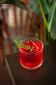 Festive pink cocktail with champagne or prosecco with ice on the table in the restaurant