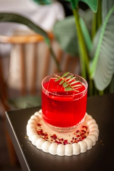 Festive pink cocktail with champagne or prosecco with ice on the table in the restaurant