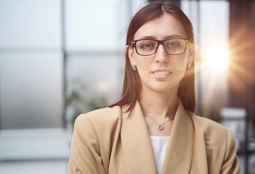 Attractive woman looking pensively at the camera in office
