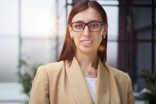 Attractive woman looking pensively at the camera in office