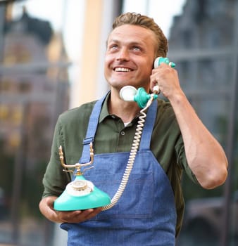 Restaurant service, administrator or waiter receiving client's call on old-fashioned phone, attentively listens to clients needs or takes reservation. Excellent customer service in restaurant industry. High quality photo