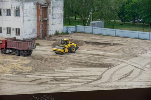 Works road machinery skating rink leveling the sand. High quality photo