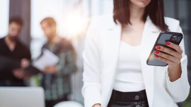 Modern gadget. Close-up of a smartphone screen in the hands of a business woman.