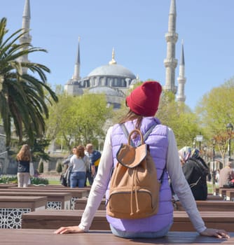 A female tourist enjoys the view of the Blue Mosque, Sultanahmet Camii, Istanbul, Turkey.