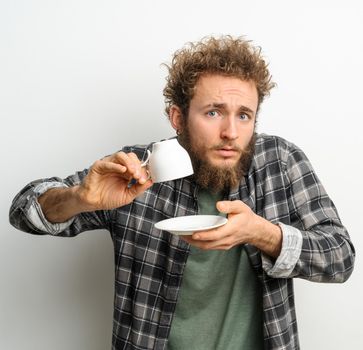 No coffee. Can i get more coffee good looking man holding inverted cup showing asking for more, guy wearing plaid long sleeve shirt isolated on white background. Crisis and lockdown concept.