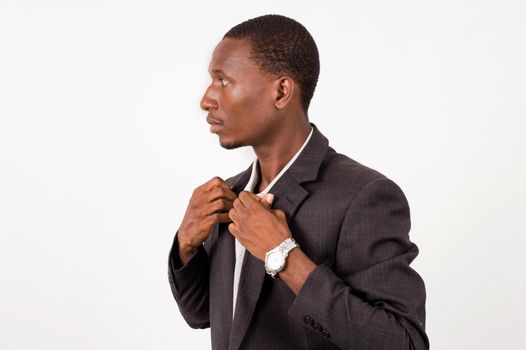 young businessman in a suit with a very serious look arranging his shirt glues for a good presentation